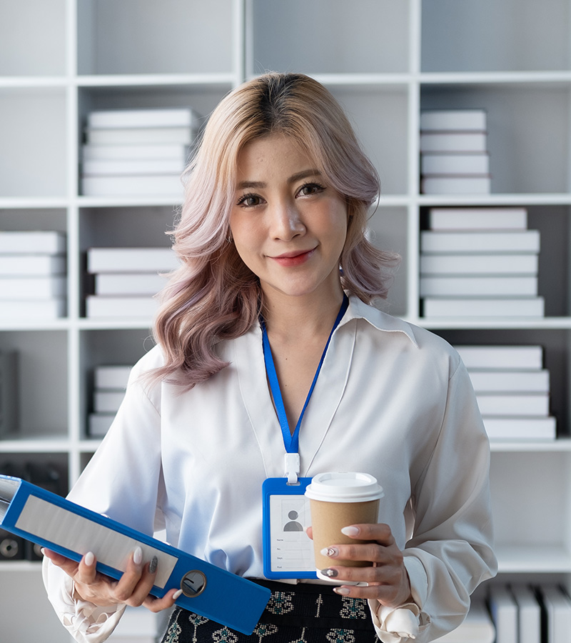 asian buinsesswoman hoding a file folder and a cof SU69HLN